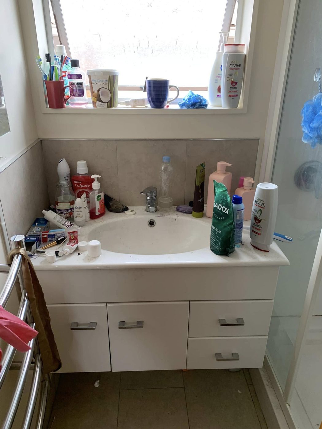 Before: a cluttered, unclean bathroom vanity